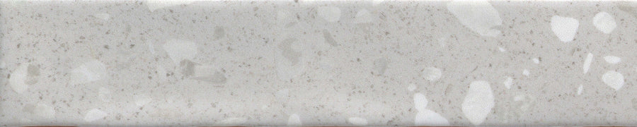 The Fragmento 2x10 Ceramic Tile in Silver Lining features a light gray, speckled terrazzo-look with scattered spots—ideal for anyone wanting bold wall tiles that offer a subtle, natural stone-like character.