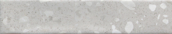 The Fragmento 2x10 Ceramic Tile in Silver Lining features a light gray, speckled terrazzo-look with scattered spots—ideal for anyone wanting bold wall tiles that offer a subtle, natural stone-like character.
