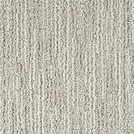 Close-up of Advocate Berber Carpet in Silver Medal, featuring a light gray hue and looped, linear pattern running vertically for a soft yet structured look.