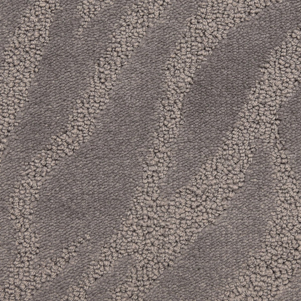 Close-up of Capetown On Trend Carpet in Silvermine, showcasing textured wavy lines in light and dark gray. Its soft, plush surface offers style and durability, making it ideal for high-traffic spaces.