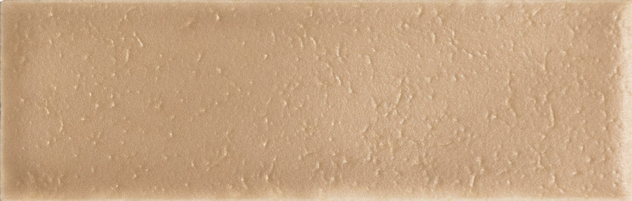 A close-up of the Skin 1.6" x 5" Matte Subway Tile in Biscuit, showcasing its rectangular shape and textured surface with subtle bumps and an elegant, timeless design.