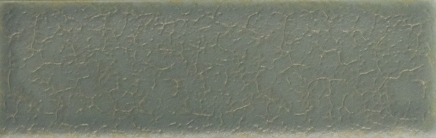 The Skin 1.6" x 5" Matte Subway Tile in Marea Blue features a rectangular, textured ceramic surface with crackled details and subtle color variations, creating an elegant, timeless look for any space.