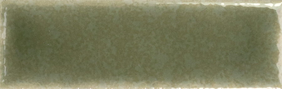 The Skin 1.6" x 5" Matte Subway Tile features a rectangular shape, moss-green hue, and slightly uneven edges, offering an elegant, timeless touch to any space with its sophisticated ceramic design.