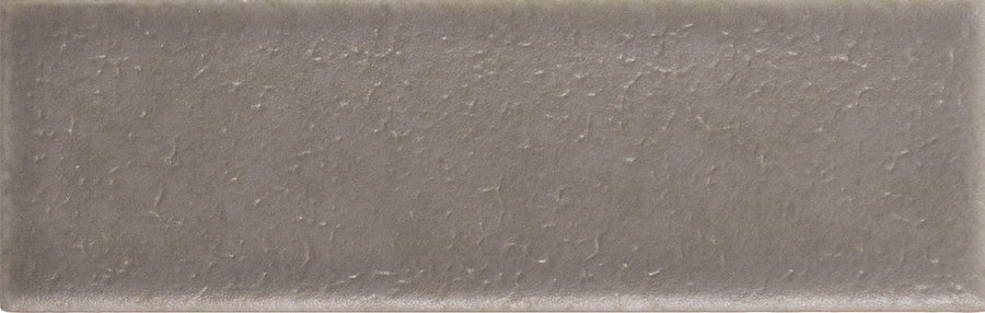 The Skin 1.6" x 5" Matte Subway Tile in Topo offers a grayish-brown hue and subtle mottled pattern, making it ideal for timeless designs in any space.