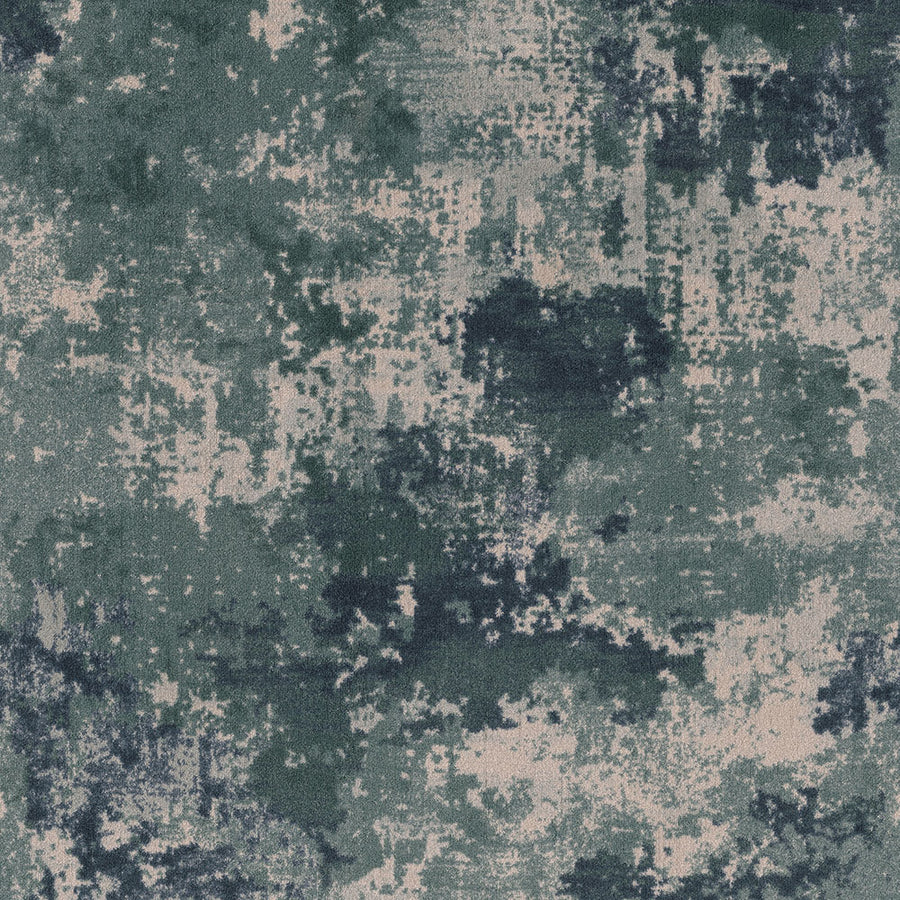 The Sky Canvas On Trend Carpet features an abstract, mottled design with uneven green, dark blue, and beige patches for a weathered, artistic look reminiscent of camouflage.