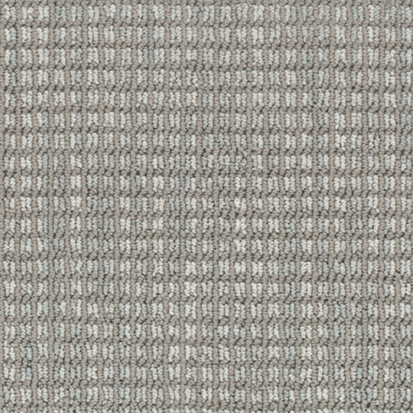 Close-up of Haven Berber Carpet in Skyline color, featuring a durable, stain-resistant surface with a grid-like rectangular weave in shades of grey and beige for a uniform, structured look.