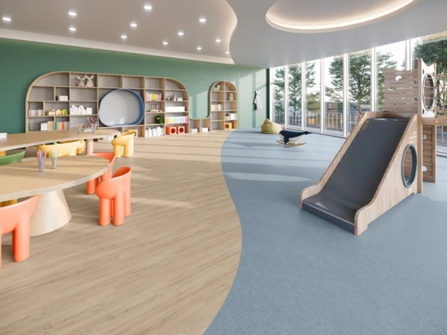 A modern, bright children's playroom features large windows, a wooden slide, round tables with orange chairs, bookshelves, toys, and a green accent wall. Commercial Vinyl flooring offers style and durability as natural light fills the room with views of trees.
