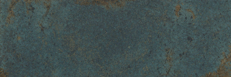 Close-up of the Catalyst 4x12 Porcelain Tile in Spark Green, highlighting its striking marbled pattern with weathered textures and subtle color variations brought out by a multi-finish glaze.