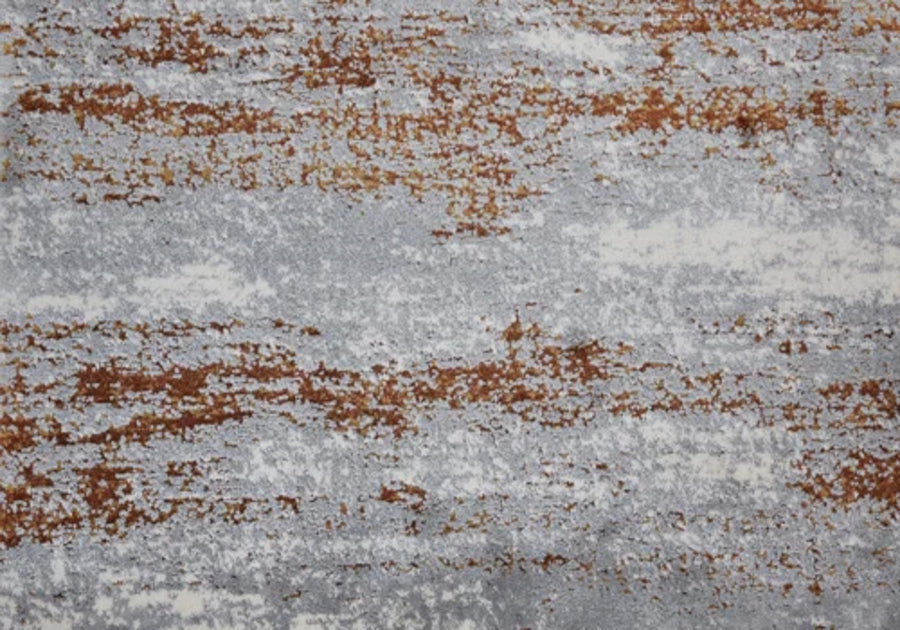 Rock And Roll On Trend Carpet in Spice features a textured surface with irregular horizontal streaks of rust brown and gray, evoking weathered metal or concrete—perfect for stylish, durable flooring in high-traffic areas.