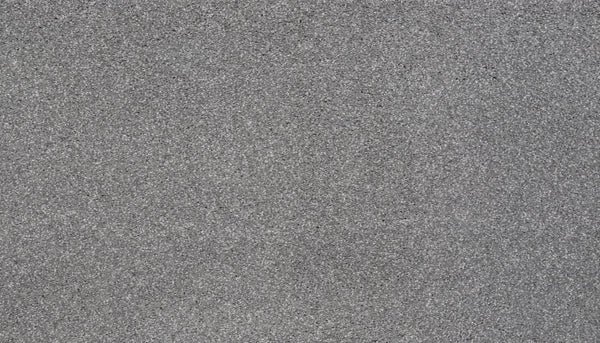 Close-up view of Splendid Elegance Pet Friendly Carpet in Cloudy Shadow, showcasing its textured gray surface with speckles, a rough granular look, and highlighting its stain resistant quality and various gray shades.