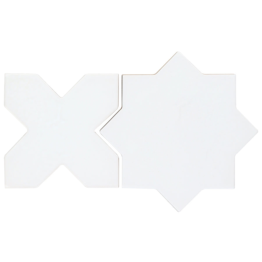 Two white Morocco Star & Cross Porcelain Tiles, one X-shaped and one eight-pointed star, are displayed side by side on a plain background to showcase their striking matte design.