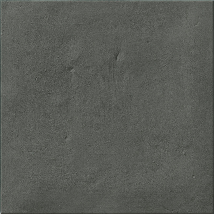 The Stardust 6" x 6" Ceramic Tile in Nero features a dark gray textured surface with subtle unevenness and small bumps, ideal for creating a concrete-like look on your backsplash or accent wall.