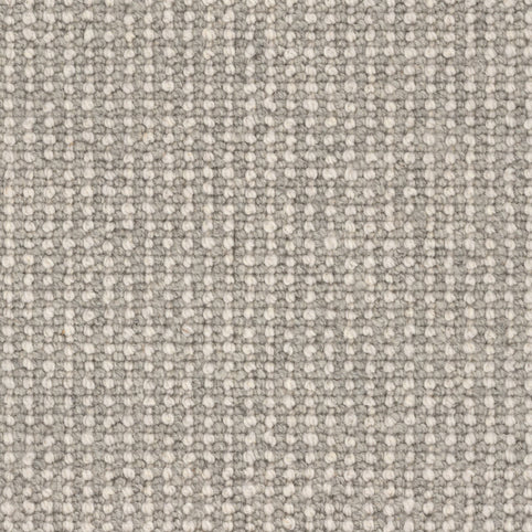 Close-up of the Andros Berber Carpet in Statue shows its light gray, grid-like woven texture with small, even loops—reflecting the durable, stylish appeal characteristic of premium Berber carpets.