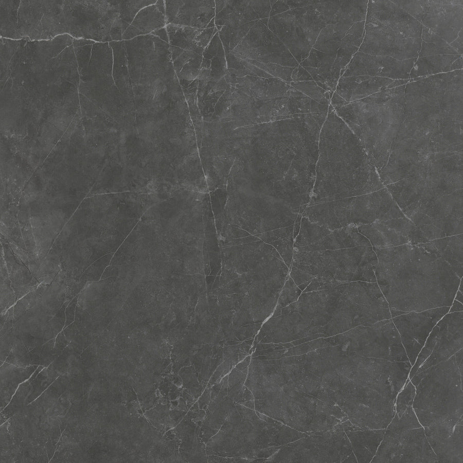 The Callie 12x12 Ceramic Tile in Smoke features natural white and light gray veining on a dark gray surface, creating an elegant, textured look.