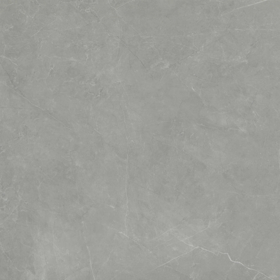The Callie 24x24 Polished Porcelain Tile in Moonlight features a smooth, light gray surface with subtle white veining and a natural texture, offering the refined look of polished marble or concrete.
