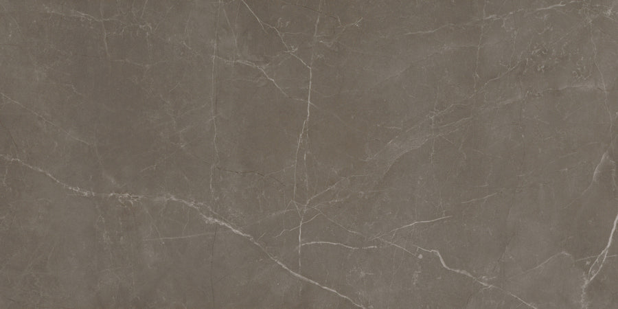 The Callie 12x24 Polished Porcelain Tile in Mocha features a dark brown marble look with white and light gray natural veins, smooth polished finish, and luxurious organic patterns—ideal for elegant interior spaces.