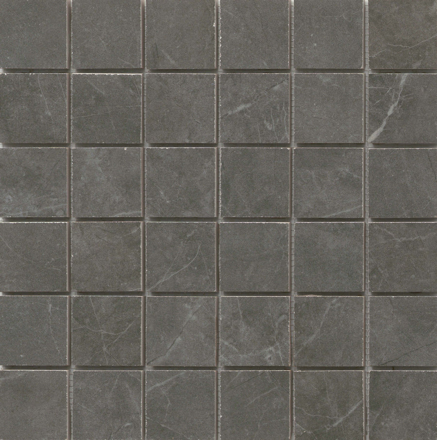 The Callie 2x2 Porcelain Mosaic in Smoke features a grid of dark gray tiles with subtle white veining, separated by thin light gray grout lines for a refined, uniform look.