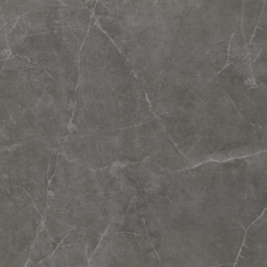 The Callie 24x24 Polished Porcelain Tile in Smoke features a dark gray marble look with white and light gray veining, offering luxury and elegance for floors, countertops, or wall tiling in any space.