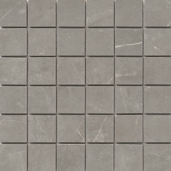The Callie 2x2 Porcelain Mosaic in Fog features small, square tiles with subtle white veining and a matte finish, creating a refined checkerboard pattern with slight variations in texture and color.