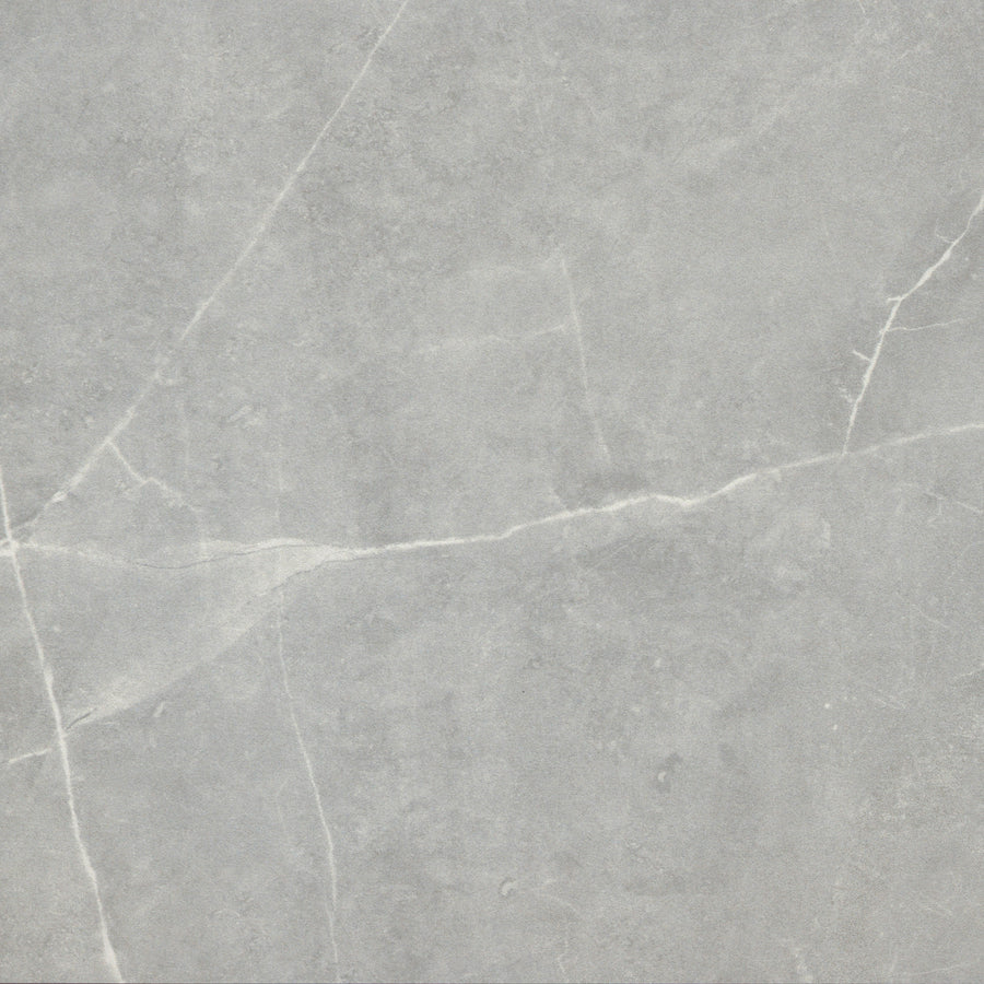 The Callie 12x12 Ceramic Tile in Moonlight features a light gray marble look with fine white veining, offering a smooth, natural stone effect ideal for creating a luxurious ceramic tile installation in any room.