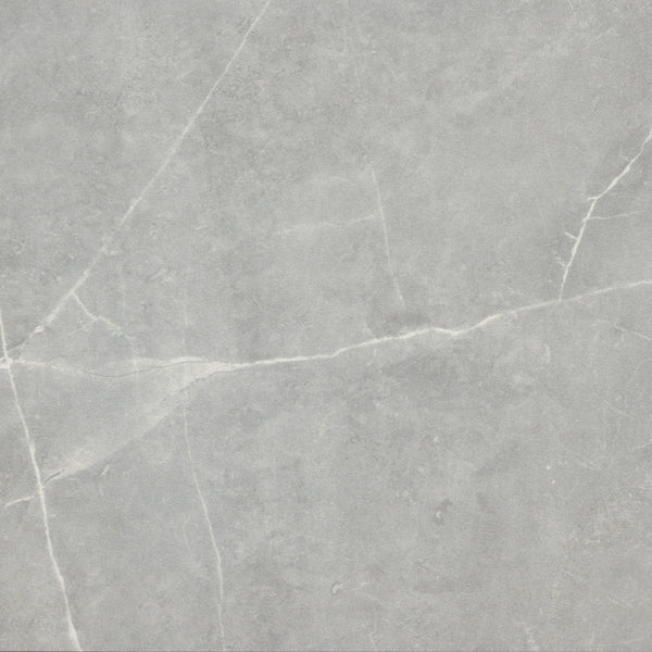 The Callie 12x12 Ceramic Tile in Moonlight features a light gray marble look with fine white veining, offering a smooth, natural stone effect ideal for creating a luxurious ceramic tile installation in any room.