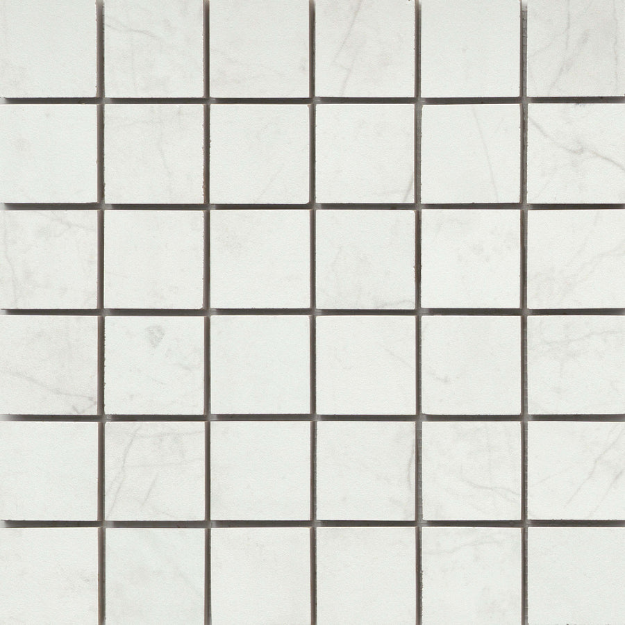 Callie 2x2 Porcelain Mosaic in Snow features square tiles with light gray veining, arranged in a checkerboard pattern and accented by thin dark grout lines for an elegant, luxury ceramic tile effect.