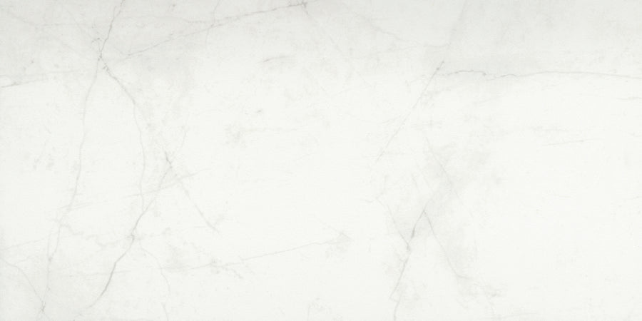 The Callie 12x24 Matte Porcelain Tile in Snow features a light gray marble look with subtle veining and soft, thin lines. Its smooth, matte finish offers a neutral and elegant appearance, perfect for modern spaces.