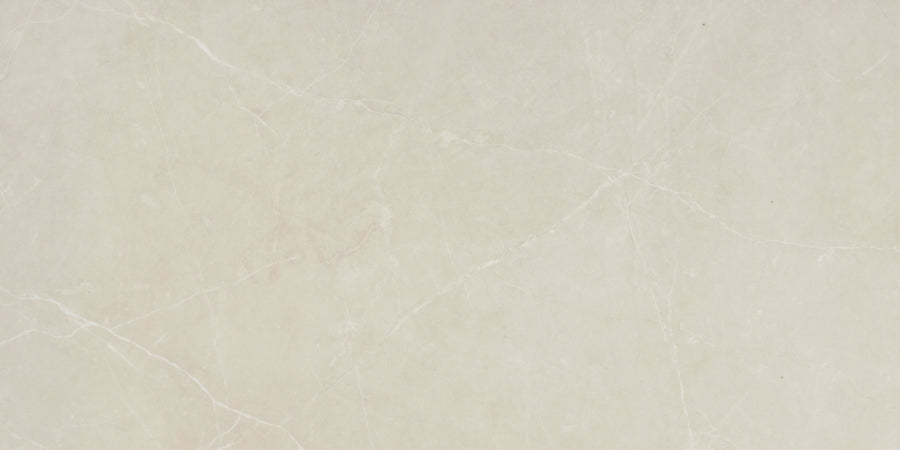 The Callie 12x24 Polished Porcelain Tile in Alabaster features a light beige marble look with soft white and grey veining, delivering a smooth texture and natural stone pattern perfect for elegant interiors.