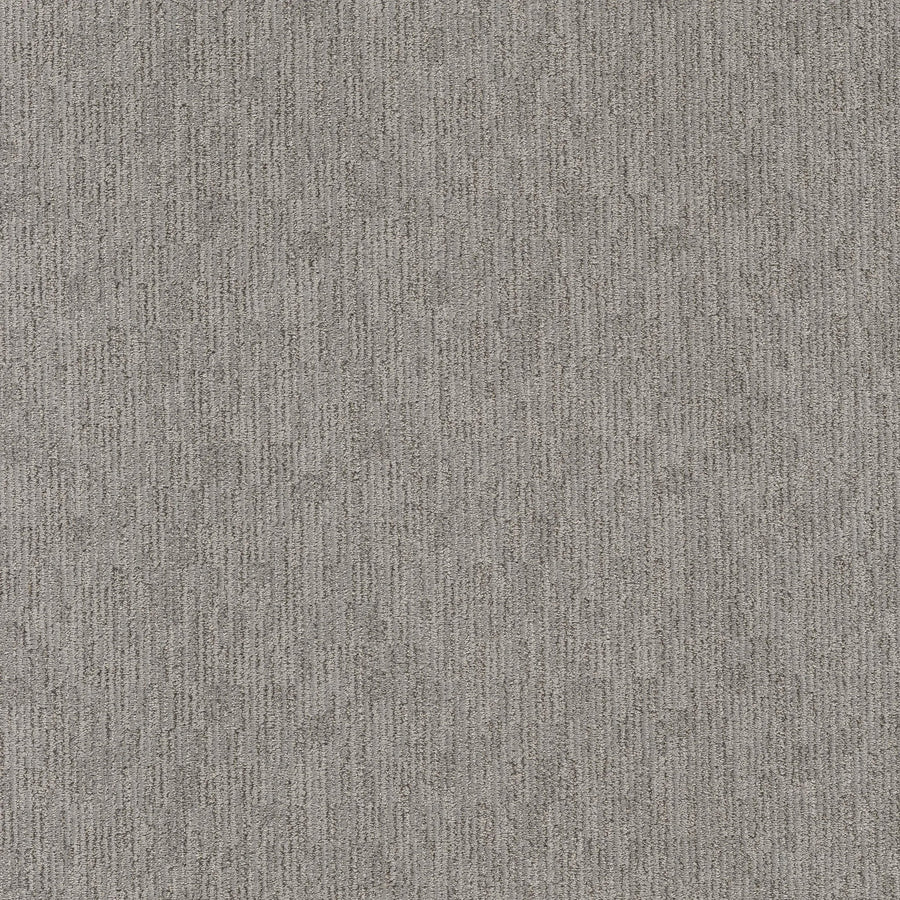 Close-up of Sneak Peak Berber Carpet in Still Gray shows a textured, dense pile with a subtle vertical linear pattern and speckled shades of grey—offering softness and durability for flooring.