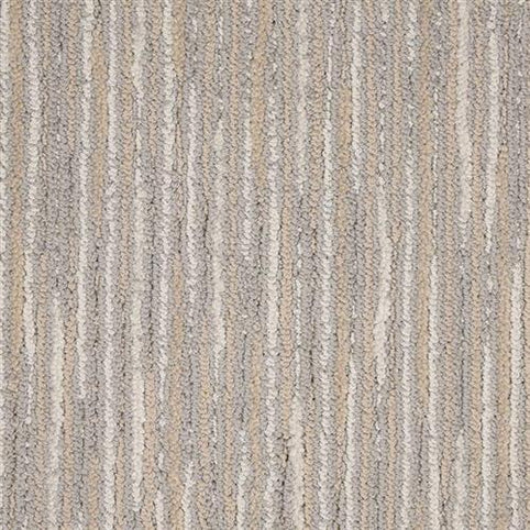 Close-up of the Artist View On Trend Carpet in Still Life, featuring a vertical striped pattern in beige, light brown, and gray tones. Its soft, slightly raised texture adds a modern touch to any space.