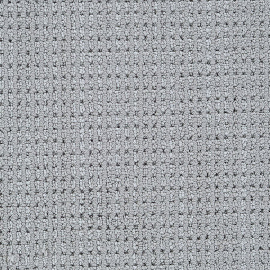 Close-up of Top Notch Berber Carpet in Stone, featuring a textured, grid-like weave with rectangular and square tufts for a soft, stylish surface that’s both premium and stain resistant.
