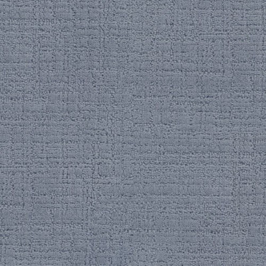 A close-up of the Bangladesh On Trend Carpet in Storm color shows its textured surface with a subtle grid-like pattern of raised and indented lines, offering a luxurious and durable finish.