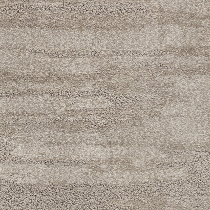 Close-up of Cirrus Berber Carpet in Stratus, featuring a textured surface with a blend of light and medium gray tones that form a subtle, mottled pattern for a sophisticated flooring look.