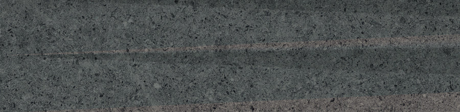 Close-up of the Stripes 3" x 12" Transitional Ceramic Tile in Graphite, showcasing a textured ceramic surface with subtle vertical streaks for a refined striped effect and natural speckled details.
