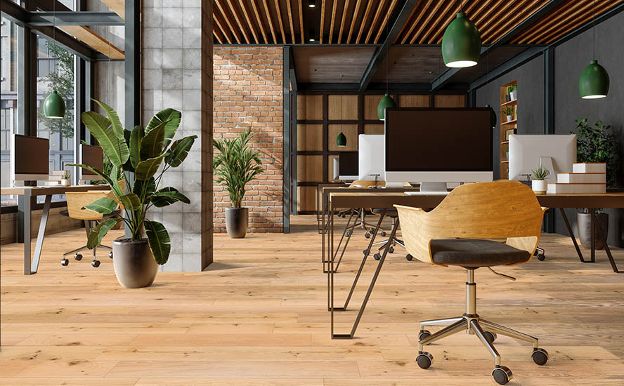 Modern open-plan office with wooden floors, computer desks, and potted plants creates the ideal workspace for your tes product. Large windows offer natural light, while exposed brick, concrete, and wooden ceiling details add stylish character.