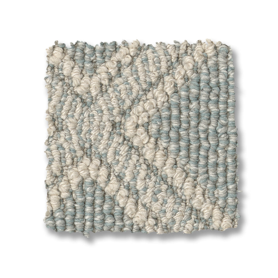 Scout Pet Friendly Carpet features a square, durable looped texture with a light blue background and a cream geometric X pattern, offering diamond-like style and pet-friendly performance.