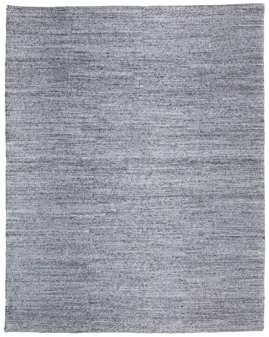 The Finley Area Rug is a rectangular, flat-woven rug in solid light gray with subtle texture and clean edges, making it an elegant addition to any home décor.