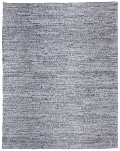 The Finley Area Rug is a rectangular, flat-woven rug in solid light gray with subtle texture and clean edges, making it an elegant addition to any home décor.