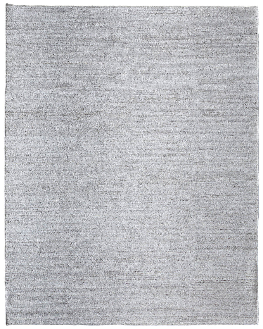 The Finley Area Rug is a large, rectangular light gray rug with a subtle mottled texture and no visible patterns—perfect for enhancing your home's décor.