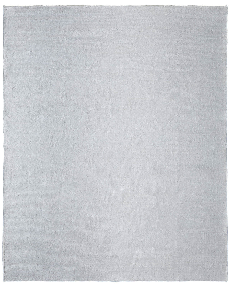 The Finley Area Rug, large and light gray with a soft, even texture, adds modern elegance to your space—ideal if you want a plush rug free of visible patterns or designs.