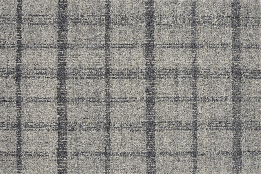 Tartan Tones On Trend Carpet in Gravel features a gray textured fabric with intersecting dark gray lines, forming uneven squares on a lighter gray background, inspired by classic Scottish plaid patterns.