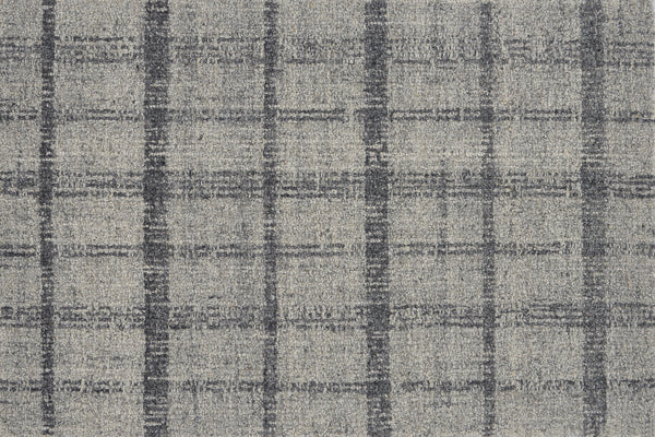 Tartan Tones On Trend Carpet in Gravel features a gray textured fabric with intersecting dark gray lines, forming uneven squares on a lighter gray background, inspired by classic Scottish plaid patterns.