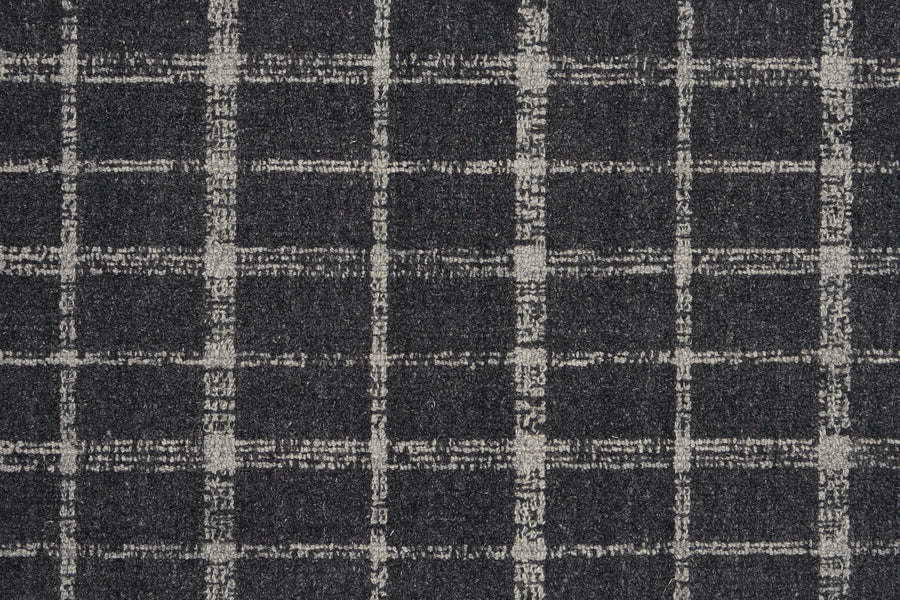 A close-up of the Tartan Tones On Trend Carpet in Mineral showcases a dark gray textured surface with a hand-drawn look, featuring light gray uneven grid lines inspired by classic Scottish plaid.