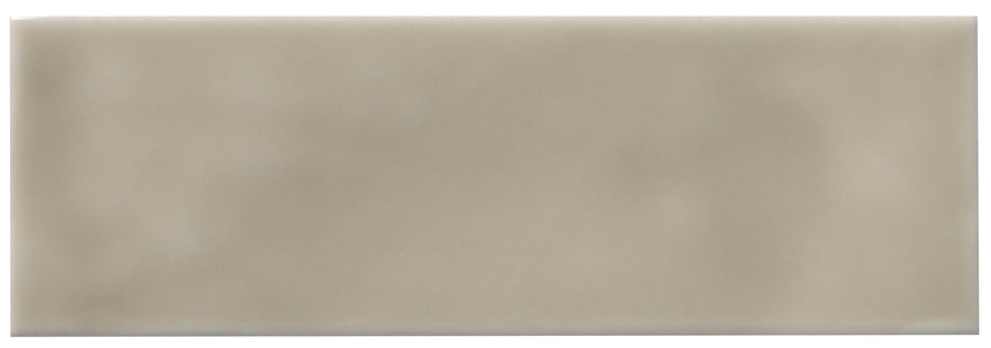 The Zephyr 2x6 Ceramic Tile is a rectangular, beige tile with a smooth, glossy finish and subtle cloudy shading that evokes handcrafted luxury inspired by Mediterranean interiors.