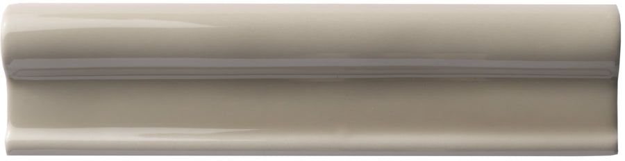The Zephyr 2x8 Rail Molding Ceramic Tile features a glossy, light taupe finish with a raised, rounded center—ideal for adding handcrafted Mediterranean luxury to your space.