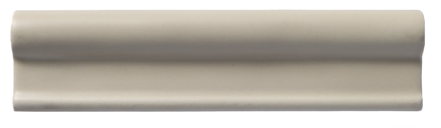 A white roll of paper evokes the smooth elegance of Zephyr 2x8 Rail Molding Ceramic Tile, inspired by handcrafted luxury Mediterranean designs.