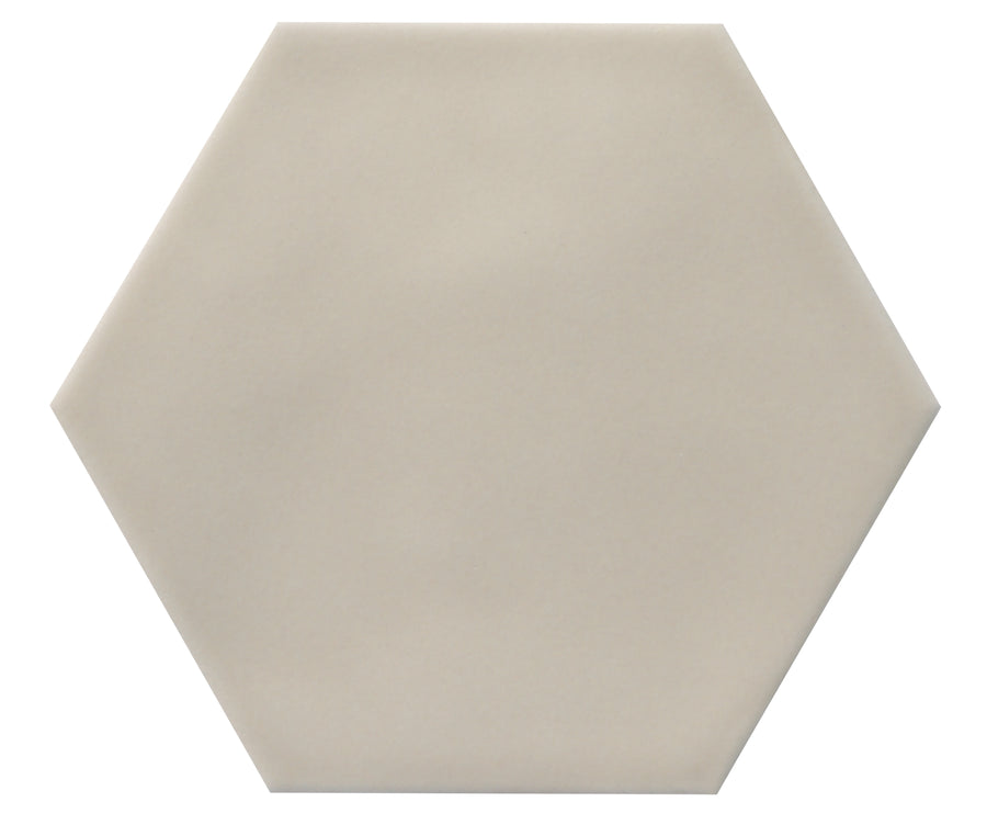 The Zephyr 4.2x4.9 Hexagon Ceramic Tile features a light beige color and smooth, straight edges, evoking the look of Mediterranean ceramic tiles against a white background.