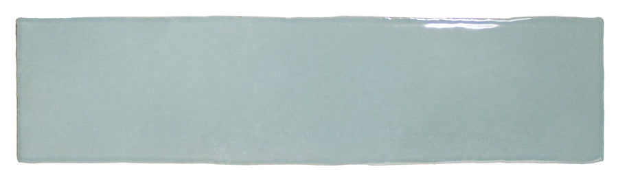 The Bali 3x12 Ceramic Subway Tile, a rectangular glossy light blue tile with slightly uneven edges and a smooth surface, is photographed against a white background to highlight its elegant, luxurious design.