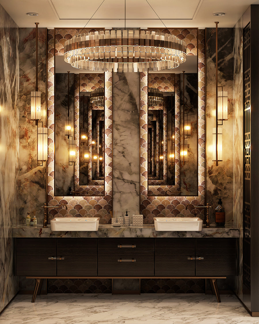 A luxurious bathroom with marble walls and floors, dual sinks, a large mirror with an ornate frame, golden pendant lights, and a decorative chandelier reflected multiple times in the mirror.
