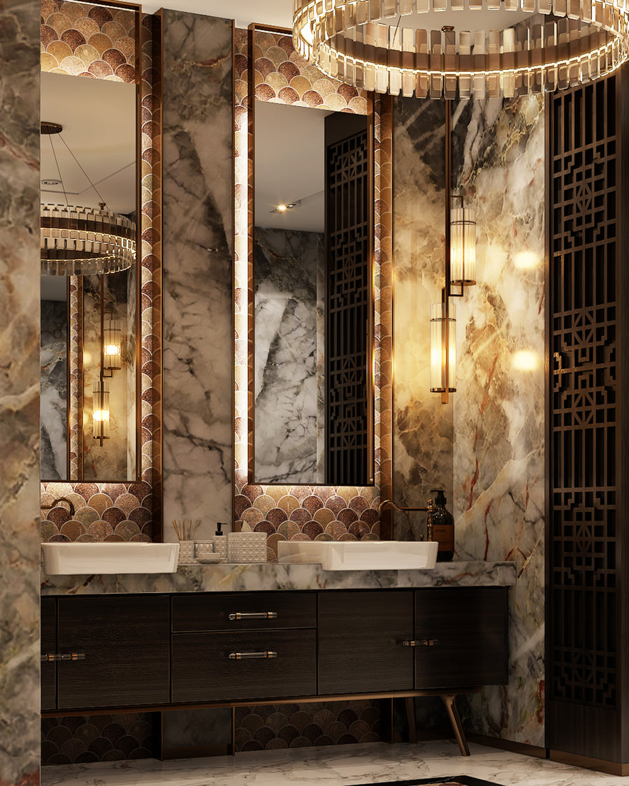 A luxurious bathroom with marble walls, double sinks, illuminated mirrors, geometric pendant lights, and an ornate wood screen. The decor features gold accents and elegant, modern design elements.